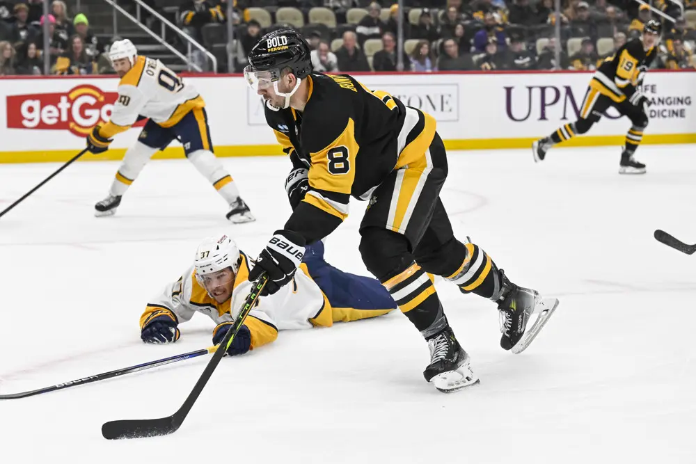 PITTSBURGH, PA - FEBRUARY 01: Pittsburgh Penguins left wing Michael Bunting (8) skates with the puck around Nashville Predators defenseman Nick Blankenburg (37) during the third period in the NHL game between the Pittsburgh Penguins and the Nashville Predators on February 1, 2025, at PPG Paints Arena in Pittsburgh, PA. (Photo by Jeanine Leech/Icon Sportswire)