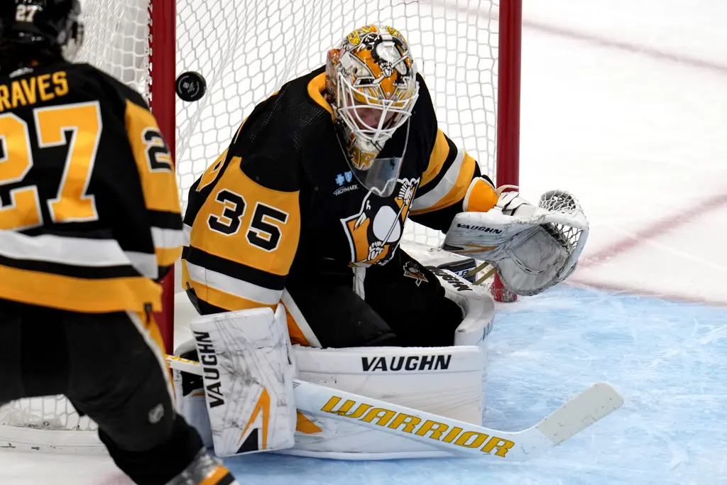 Pittsburgh Penguins game, Ryan Graves and Tristan Jarry.