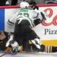 Dallas Stars' Evgenii Dadonov (63) checks Pittsburgh Penguins' Ryan Graves (27) into the boards during the first period of an NHL hockey game in Pittsburgh, Monday, Nov. 11, 2024. (AP Photo/Gene J. Puskar)