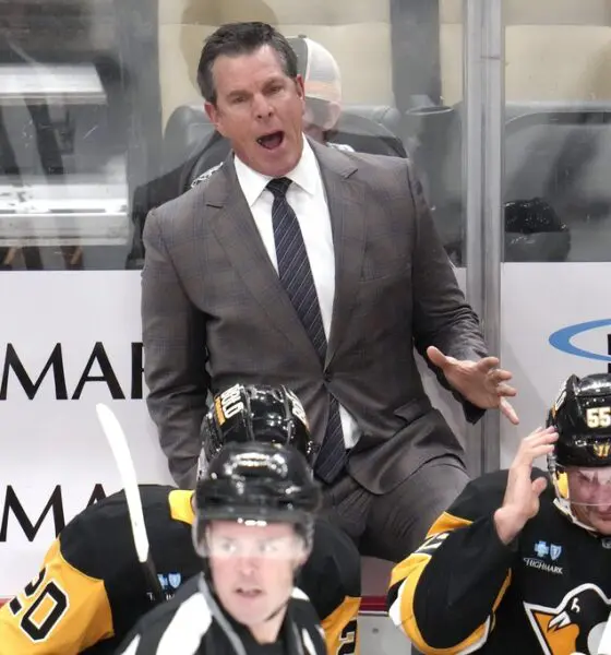 Pittsburgh Penguins head coach Mike Sullivan makes his point to linesman Matt MacPherson (83) during the first period of an NHL hockey game against the Dallas Stars in Pittsburgh, Monday, Nov. 11, 2024. (AP Photo/Gene J. Puskar)