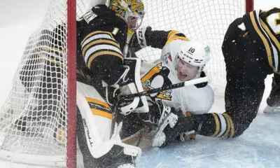 Drew O'Connor and Boston goalie Jeremy Swayman