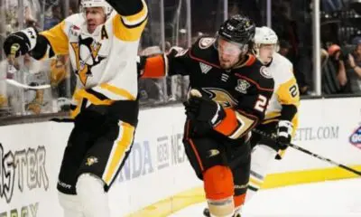 Pittsburgh Penguins center Evgeni Malkin, left, reacts after making contact with Anaheim Ducks center Mason McTavish, who lost his stick, during the second period of an NHL hockey game Tuesday, Nov. 7, 2023, in Anaheim, Calif. (AP Photo/Ryan Sun)