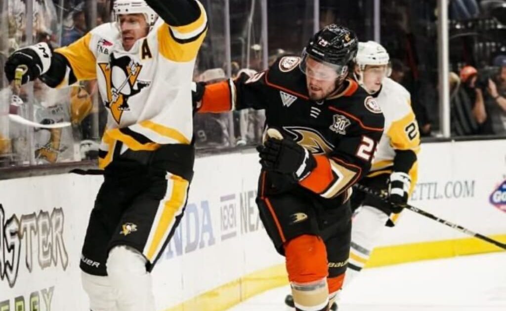 Pittsburgh Penguins center Evgeni Malkin, left, reacts after making contact with Anaheim Ducks center Mason McTavish, who lost his stick, during the second period of an NHL hockey game Tuesday, Nov. 7, 2023, in Anaheim, Calif. (AP Photo/Ryan Sun)