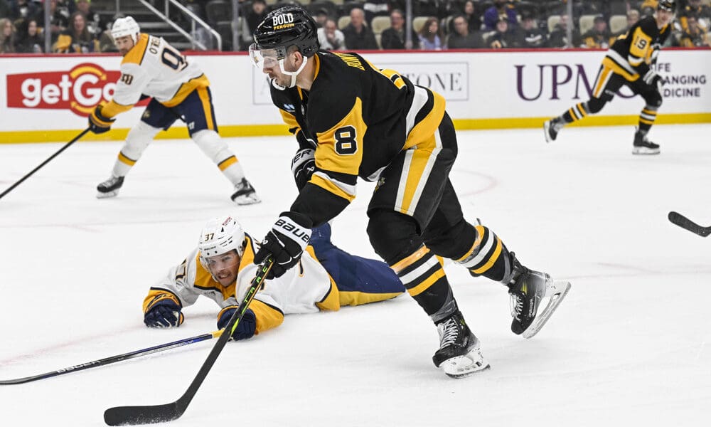 PITTSBURGH, PA - FEBRUARY 01: Pittsburgh Penguins left wing Michael Bunting (8) skates with the puck around Nashville Predators defenseman Nick Blankenburg (37) during the third period in the NHL game between the Pittsburgh Penguins and the Nashville Predators on February 1, 2025, at PPG Paints Arena in Pittsburgh, PA. (Photo by Jeanine Leech/Icon Sportswire)