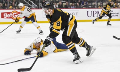 PITTSBURGH, PA - FEBRUARY 01: Pittsburgh Penguins left wing Michael Bunting (8) skates with the puck around Nashville Predators defenseman Nick Blankenburg (37) during the third period in the NHL game between the Pittsburgh Penguins and the Nashville Predators on February 1, 2025, at PPG Paints Arena in Pittsburgh, PA. (Photo by Jeanine Leech/Icon Sportswire)