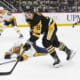 PITTSBURGH, PA - FEBRUARY 01: Pittsburgh Penguins left wing Michael Bunting (8) skates with the puck around Nashville Predators defenseman Nick Blankenburg (37) during the third period in the NHL game between the Pittsburgh Penguins and the Nashville Predators on February 1, 2025, at PPG Paints Arena in Pittsburgh, PA. (Photo by Jeanine Leech/Icon Sportswire)