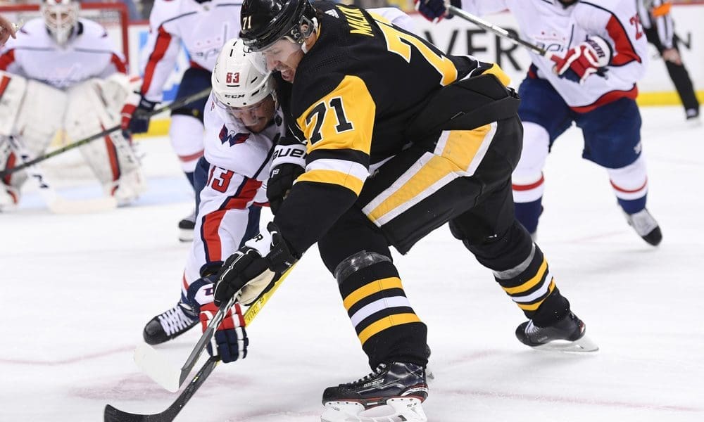 Pittsburgh Penguins Evgeni Malkin battles for a loose puck