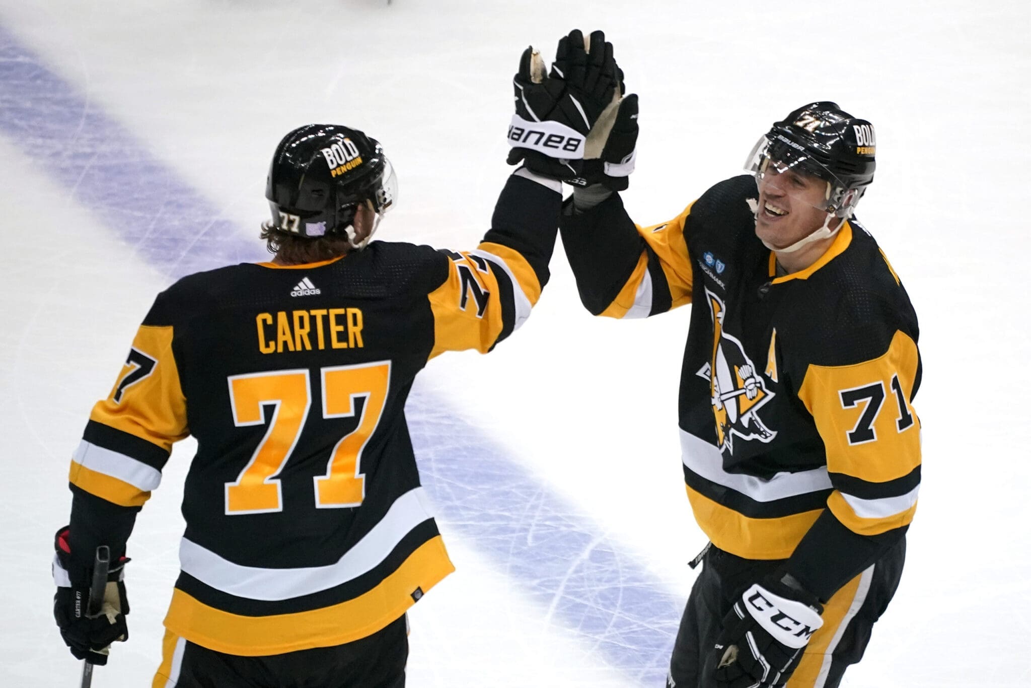 Pittsburgh Penguins center Jeff Carter (77) skates with the puck during the  first period of an